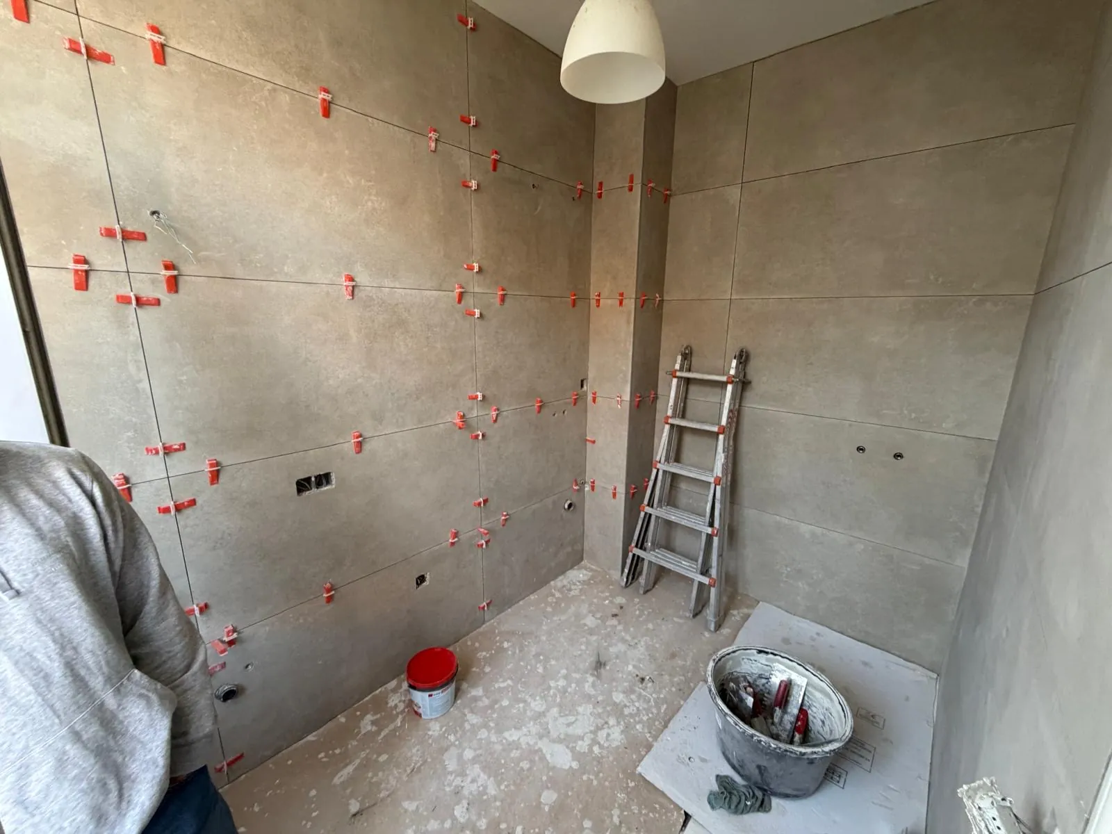 Grootformaat wandtegels met nivelleerclips tijdens een badkamerrenovatie door HS Concept in Aalst